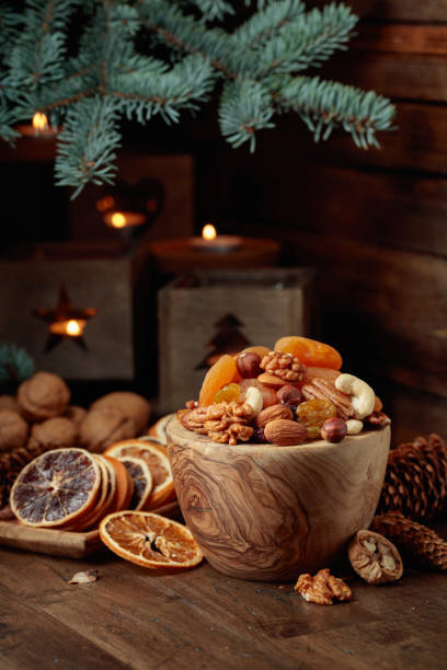 istock Dried fruits and assorted nuts on an old wooden table. 1440583619