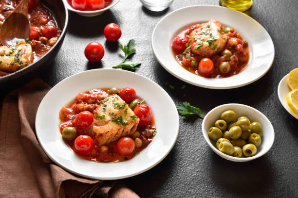 Cod stew with chickpeas, cherry tomatoes and olives stock photo