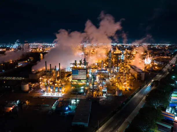 Photo of Aerial View of Massive Refinery Complex with American Flag at Night