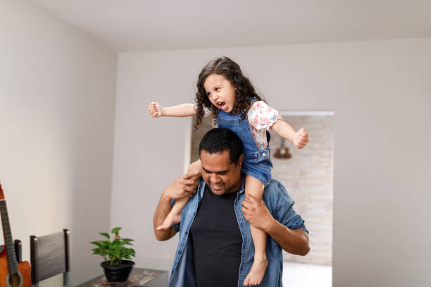 istock Father playing with his daughter on his shoulders 1440587533