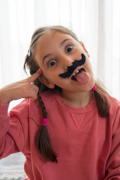 istock Mustached Little Girl 1440589356