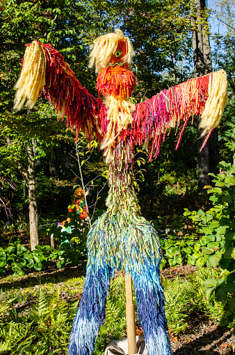 A spooky scarecrow keeping watch by a garden