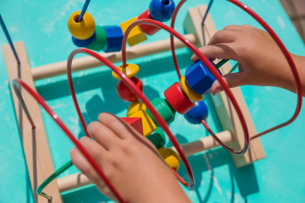 istock Kid playing with educational toy at home. little kid playing developing games for kids. Happy child playing colorful toys. Educational toy. Developing games.Wooden eco-friendly 1440591096