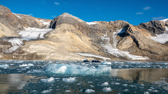 visitors to Svalbard view glaciers from zodiacs