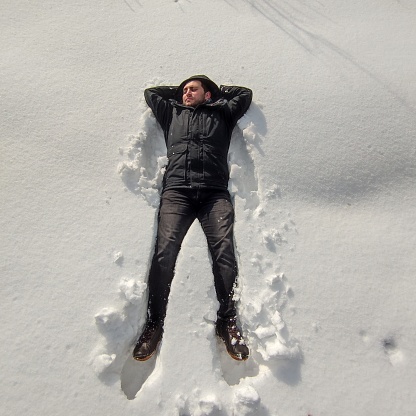 man lying in snow