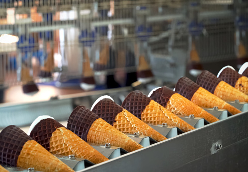 Ice cream cones on a conveyor. Ice cream factory.