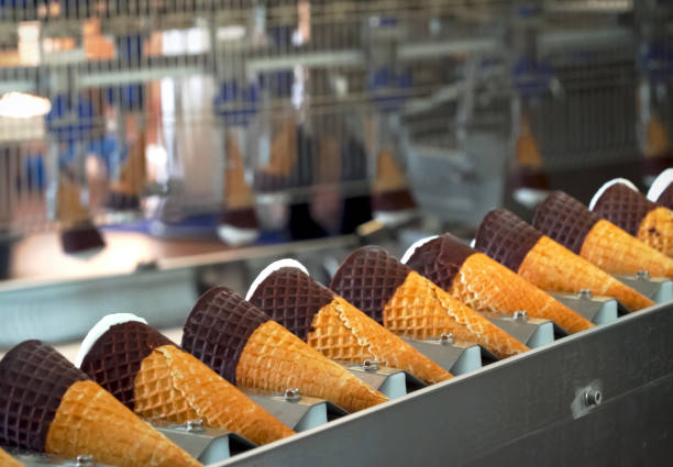 ice cream cones on conveyor. ice cream factory. - semi skimmed milk imagens e fotografias de stock