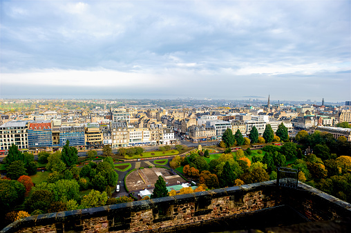 A view of Princes Street Gardens and Princes Street from high atop Edinburgh Castle in Edinburgh Scotland.  Princes Street is one of the main shopping streets in Edinburgh.