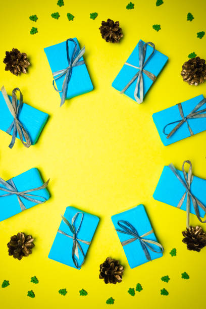 istock Yellow blue Christmas and New Year background with gift box and decorations, flat lay. 1440602753