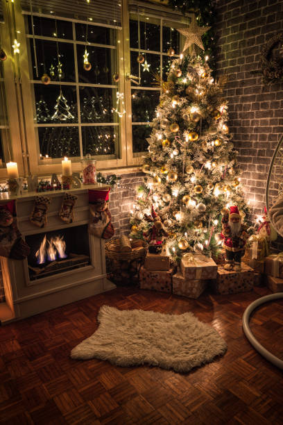 istock Decorated Christmas Tree Near Fireplace at Home 1440605424