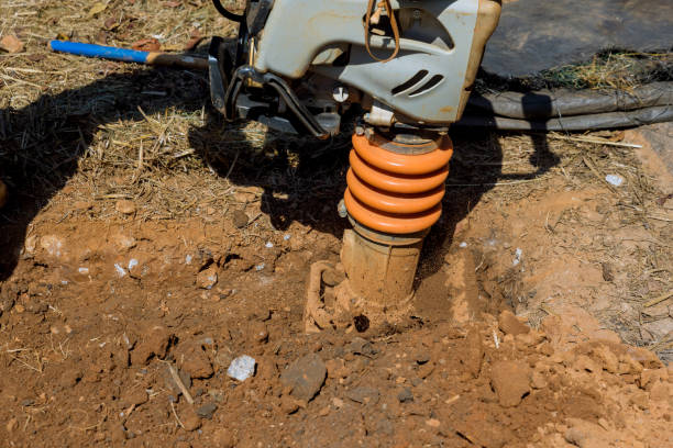 la piastra vibrante di un utensile compattatore di pressatura salta al momento della compattazione a terra in un cantiere - jumping jack compactor foto e immagini stock