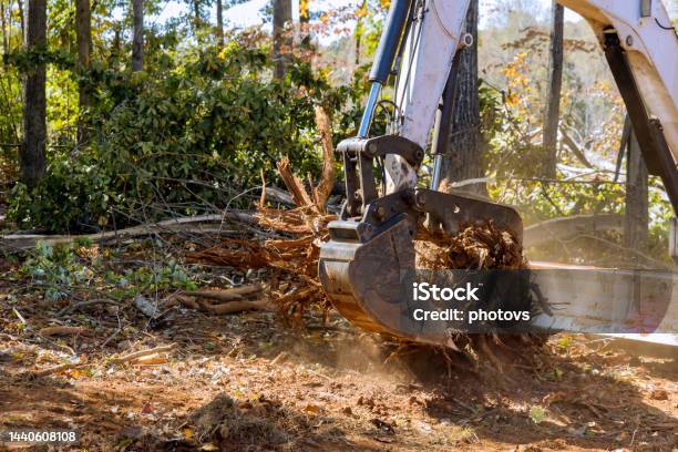 A Landscaping Company Was Using Tractors And Skid Steers And Tractors To Clear The Land Of Roots For The Construction Of A Housing Subdivision In A Residential Area Stock Photo - Download Image Now