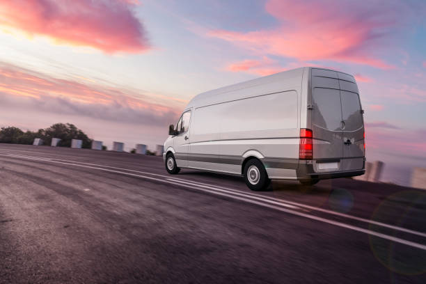 grey colored van driving fast on freeway for overnight express dilevery 3d rendering of Van or truck of freight forwarder or shipping company on the road quickly delivers packages and deliveries overnight transporter stock pictures, royalty-free photos & images