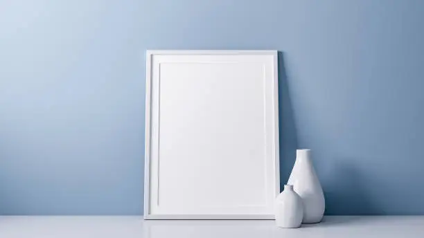 3D rendering of blank photo or picture frame in front of blue wall as template or mockup with vase as decoration in room at home with copy space