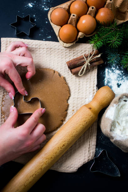 istock Christmas cooking and baking, female hands making cookies from dough 1440610649