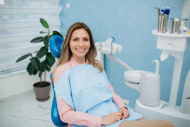 istock Happy woman visiting a dentist office 1440611064