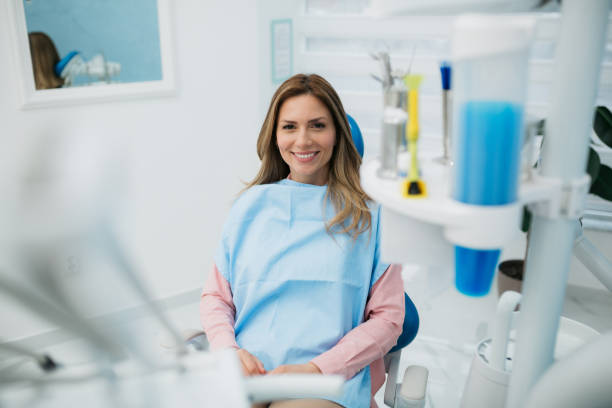 istock Happy woman visiting a dentist office 1440611201