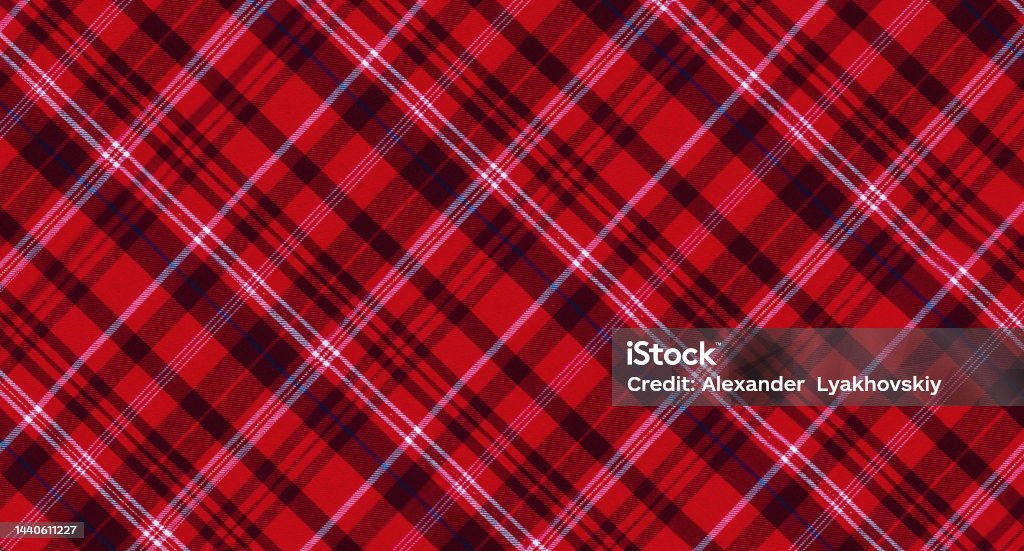 Christmas red textile plaid. Checkered background. Checkered red background. Christmas red textile plaid. Tablecloth with striped texture pattern. Antique Stock Photo