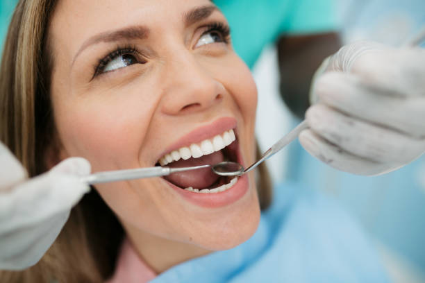 istock Beautiful woman visiting her dentist 1440611932
