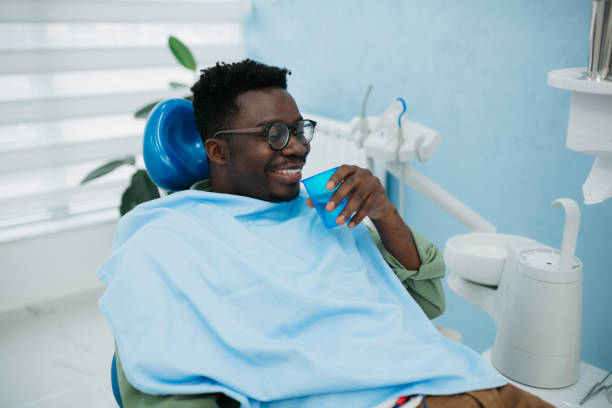 istock Young man sitting in a dentist chair 1440614446