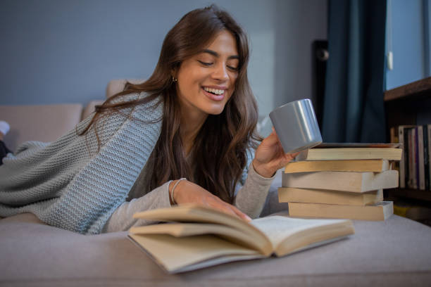 istock Woman relaxing and reading a book 1440614532