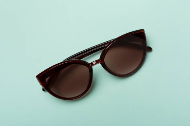 istock Sunglasses on color background, top view 1440614706