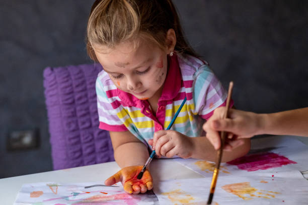istock Little girls play with tempera 1440617858