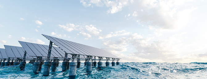 3D panorama of contemporary solar panels installed in sea water against cloudy sunrise sky