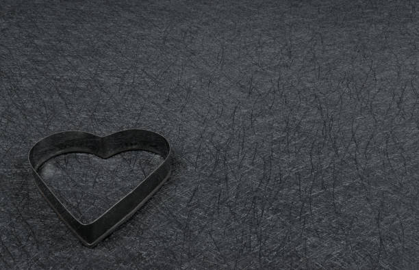 istock Steel heart frame on black background. Beautiful copy space. 1440618804