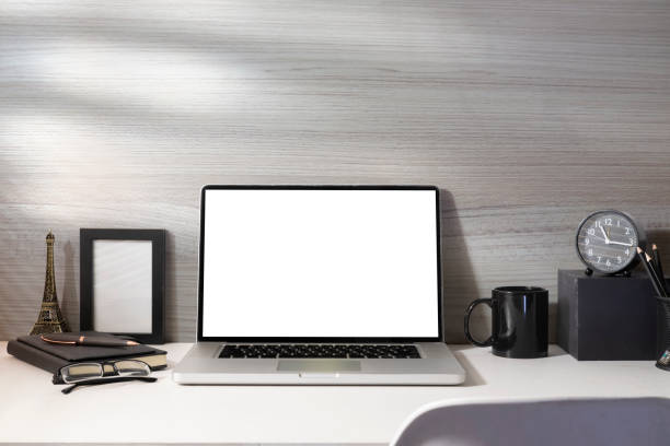 istock Laptop computer, alarm clock, coffee cup, picture frame and glasses. Empty screen for your advertise text. 1440628443