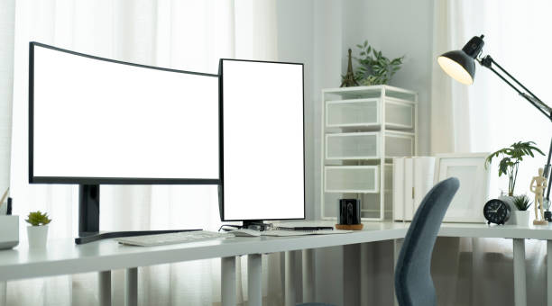 istock Modern workplace with large curved and vertical computer monitor on a white table. Blank Screen for your advertise text. 1440631501