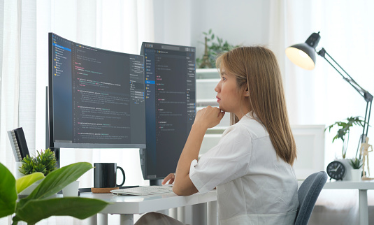 Concentrated Female Software Developer Reading Analyzing Data ...