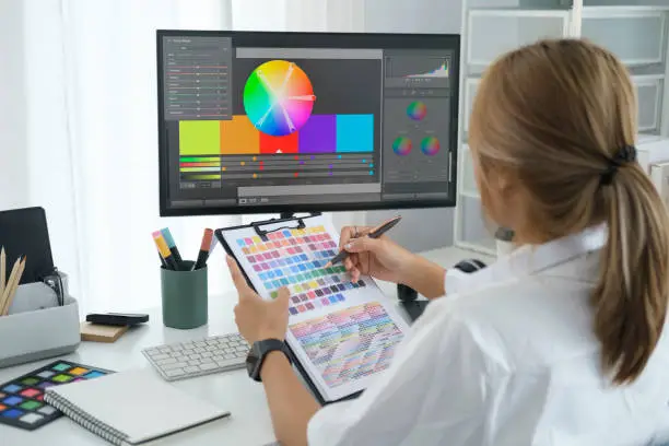 Cropped shot of young creative woman using graphics tablet and a stylus pen at modern workplace.