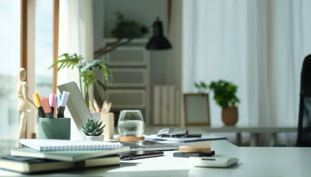istock Comfortable home office with laptop computer, houseplant and supplies. 1440634081