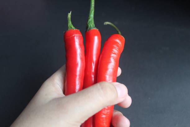 istock big red chili in someone's hand 1440635044