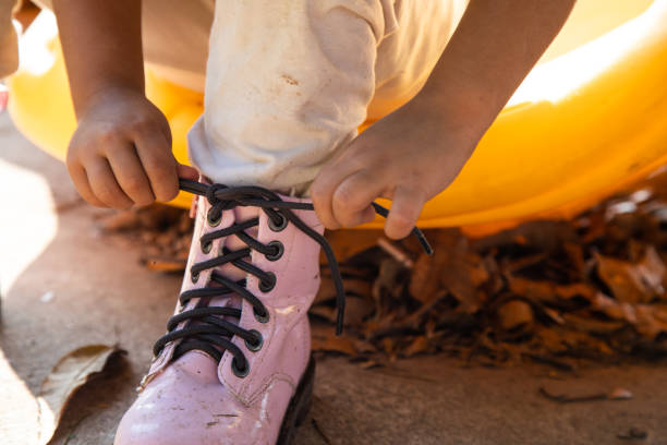 Little girl tying her shoelaces