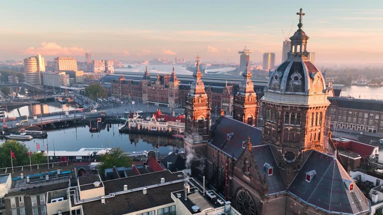 Aerial view of famous places Amsterdam, Netherlands. View of canal and old centre district. railway station Amsterdam Centraal view