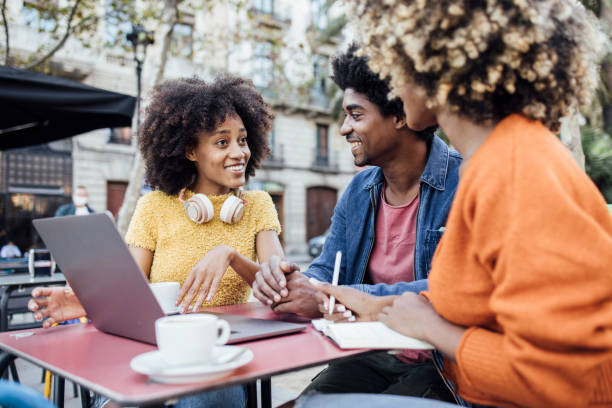 istock Three Afro friends in Barcelona sitting at the cafe  and working 1440640907