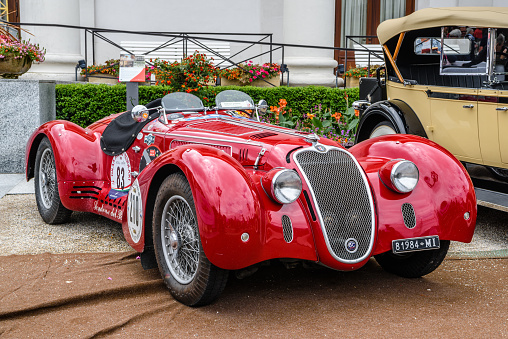 Baden-Baden, Germany - 14 July 2019: red Alpha Romeo 8C 2900B Touring Spider 1937 cabrio roadster, oldtimer meeting in Kurpark.
