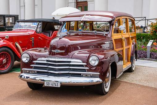 Baden-Baden, Germany - 14 July 2019: dark red Chevrolet Fleetline Sportmaster 1942, oldtimer meeting in Kurpark.