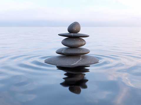 Zen stones in water with reflection - peace balance meditation relaxation concept