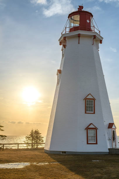 Panmure island Lighthouse Sunrise Morning sunrise at Panmure Island Lighthouse, PEI, Canada, as the last of the snow melts. cavendish beach at prince edward island national park canada stock pictures, royalty-free photos & images