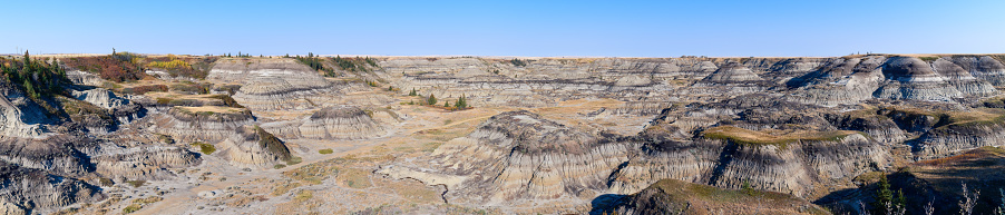 Man hiking with backpack on top of Badlands.