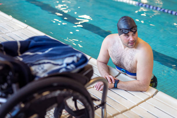 istock Adaptive Athlete Resting In Swimming Pool During Practice Session 1440646669