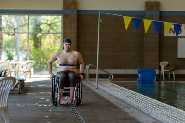 istock Adaptive Athlete Rolling In His Wheelchair By Community Center Pool 1440646691