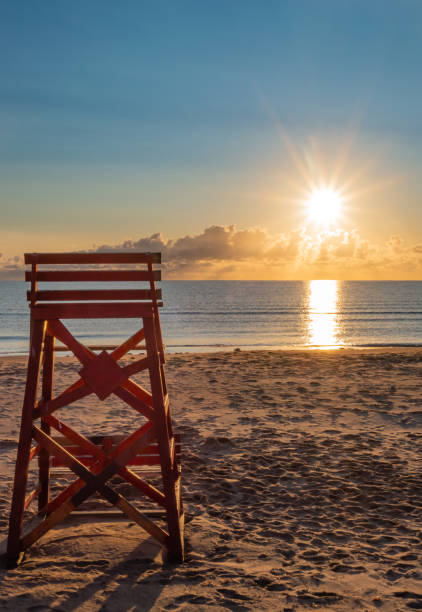 Lifeguard chair with early morning PEI beach sunrise. stock photo