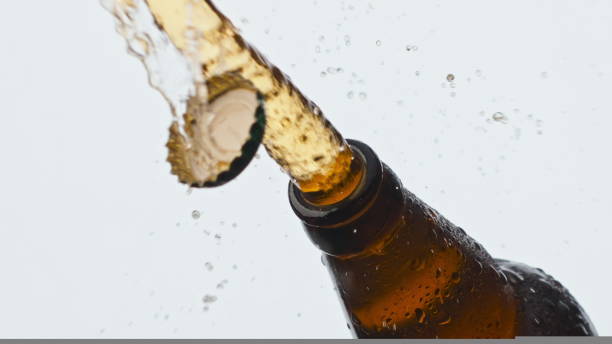 istock Cider splashing misted flask closeup. Cold lager beverage foaming fountaining 1440651942