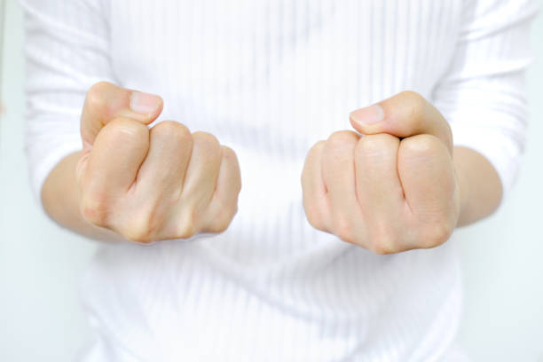 Man's hand clenched, showing stressful and angry behavior from work. feeling of dissatisfaction Medical concepts and emotional regulation