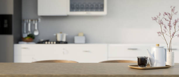 istock Copy space on minimal wood dining table with teapot, coffee cup and ceramic flower vase 1440656066