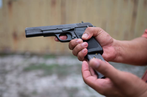 Close up shot of person loading firearm